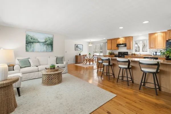 a living room with lots of furniture and kitchen view