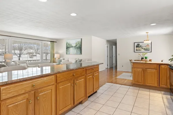 a large bathroom with a large mirror vanity and toilet