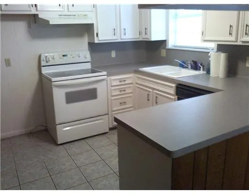 a kitchen with cabinets appliances and a sink