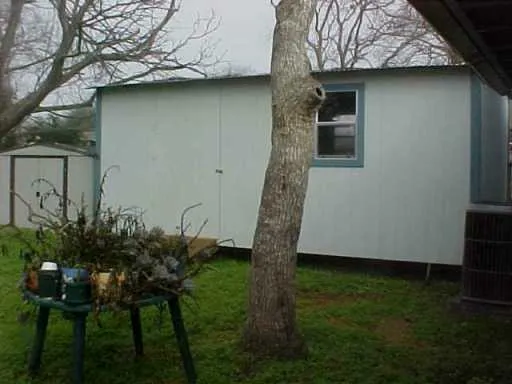 a backyard of a house with table and chairs