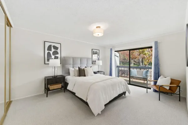 a bedroom with a bed and a large window