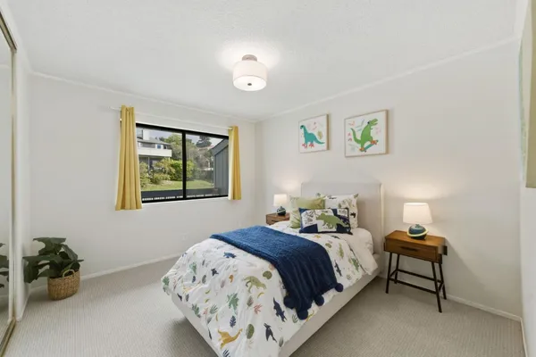 a bedroom with a bed and a window