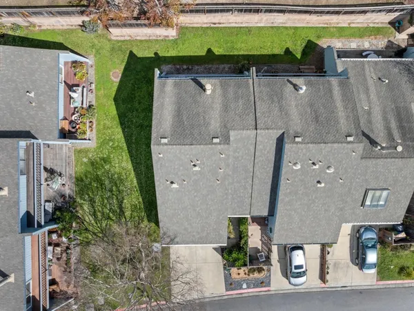 an aerial view of a house with a yard and parking space
