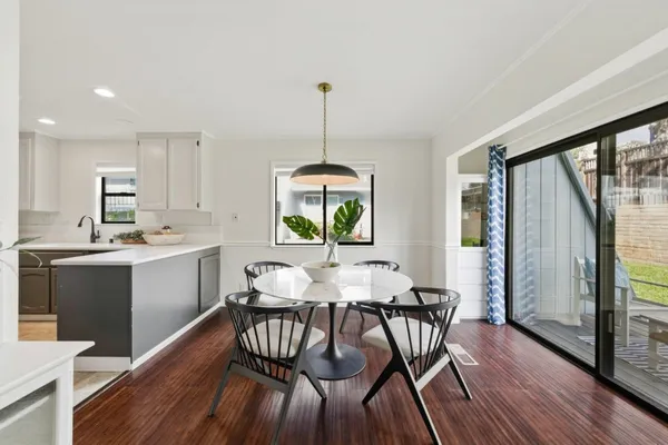 a view of a dining room with furniture window and wooden floor