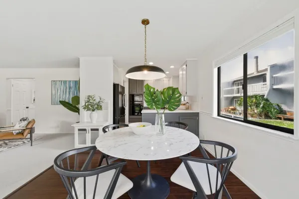 a dining room with furniture and window