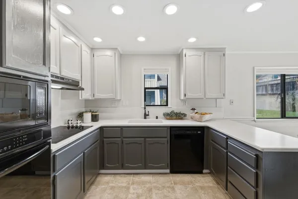 a kitchen with a sink stove top oven and cabinets