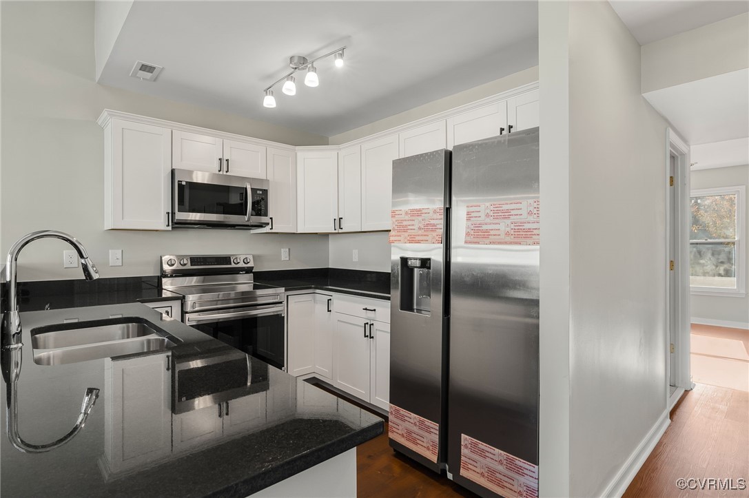 1301 Tree Ridge Road Henrico, VA 23231 - Photo 13 of 33 a kitchen with kitchen island a counter top space cabinets and stainless steel appliances