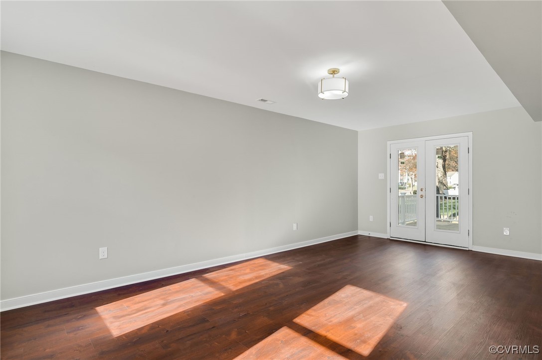1301 Tree Ridge Road Henrico, VA 23231 - Photo 7 of 33 an empty room with wooden floor and windows
