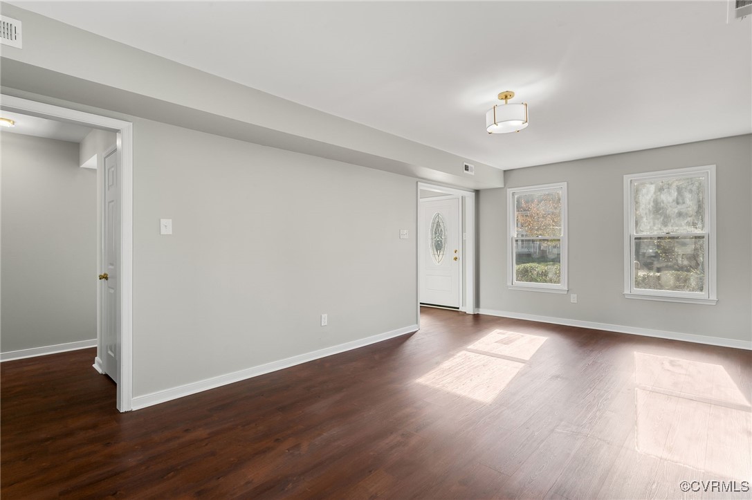 1301 Tree Ridge Road Henrico, VA 23231 - Photo 9 of 33 a view of an empty room with wooden floor and a window