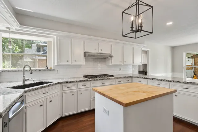 a kitchen with a sink cabinets and window