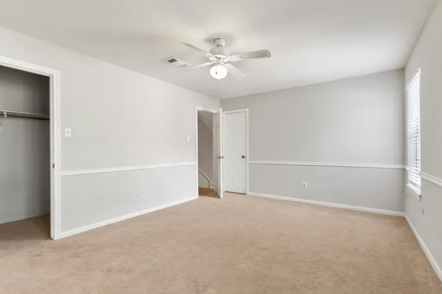 a view of a livingroom with a ceiling fan and window