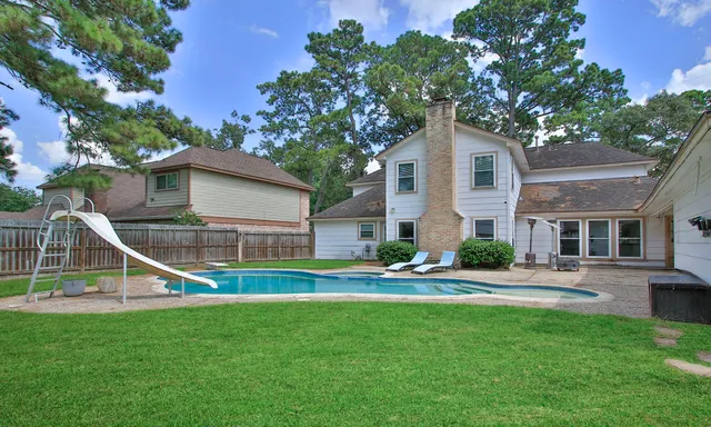 a house view with a garden and trees