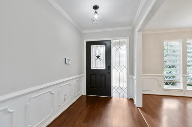 a view of an entryway with wooden floor