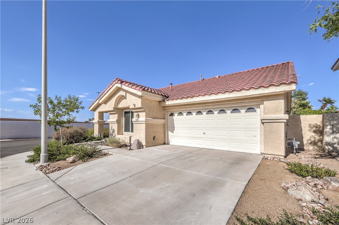 1900 Cardinal Point Street Henderson, NV 89012 - Photo 1 of 32 A single-story dwelling with a tiled roof and an attached garage offers inviting curb appeal.