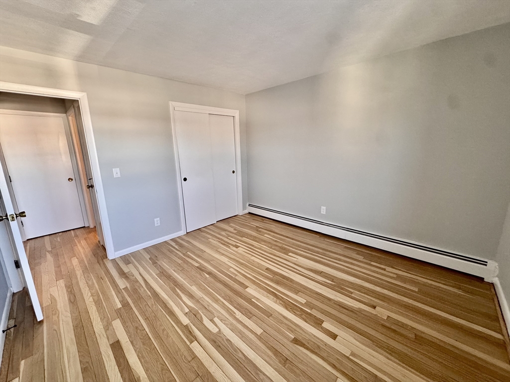 97 Spring Street, Unit C6 Boston, MA 02132 - Photo 5 of 8 a view of a room with wooden floor