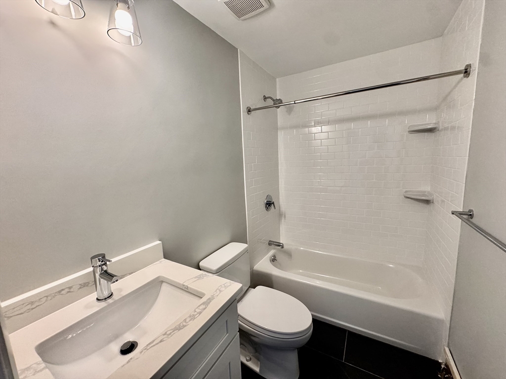 97 Spring Street, Unit C6 Boston, MA 02132 - Photo 6 of 8 a bathroom with a sink toilet tub and shower