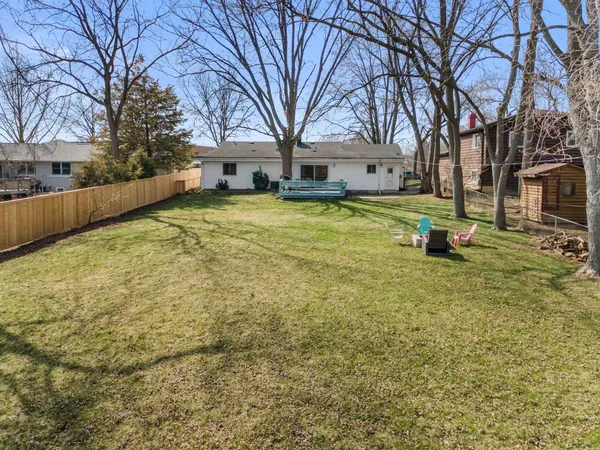 a swimming pool with outdoor seating and yard