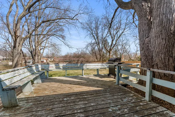 a view of a yard with wooden fence