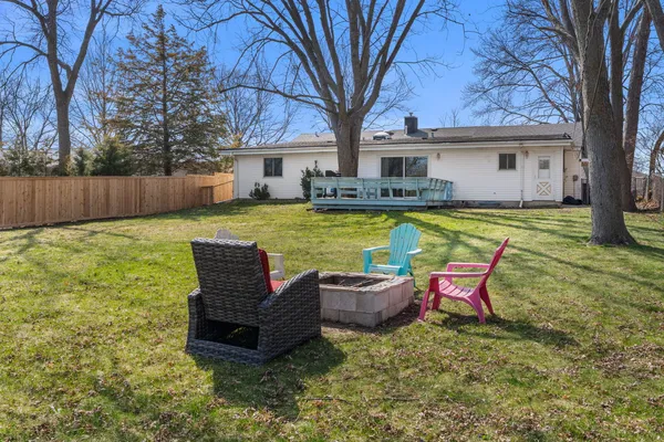 a view of a house with a yard chairs and a small pool