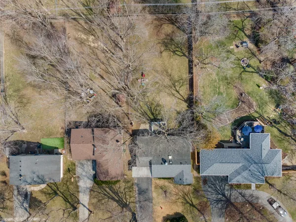 an aerial view of a house with a yard