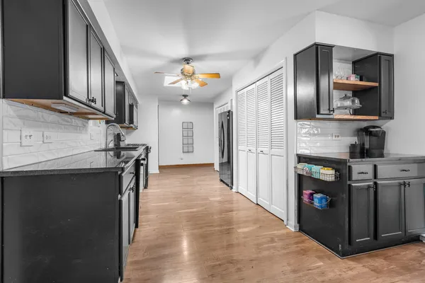 a kitchen with stainless steel appliances granite countertop a refrigerator and a sink