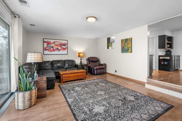 a living room with furniture and wooden floor