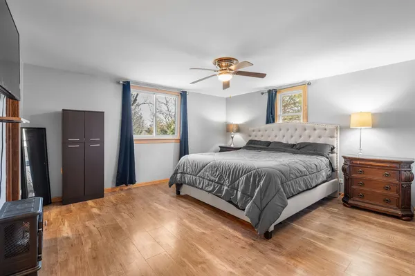 a bedroom with a bed and a lamp