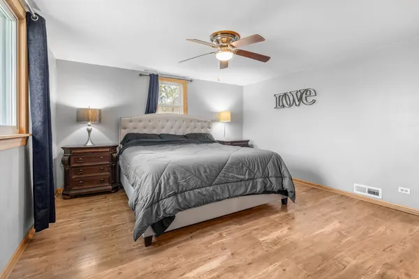 a bedroom with a bed and a chandelier