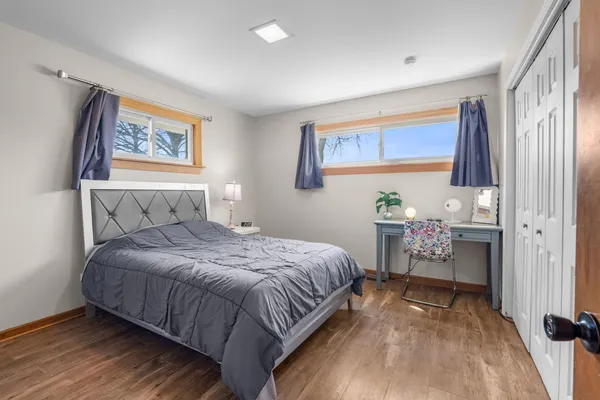 a bedroom with a bed and a painting on the wall