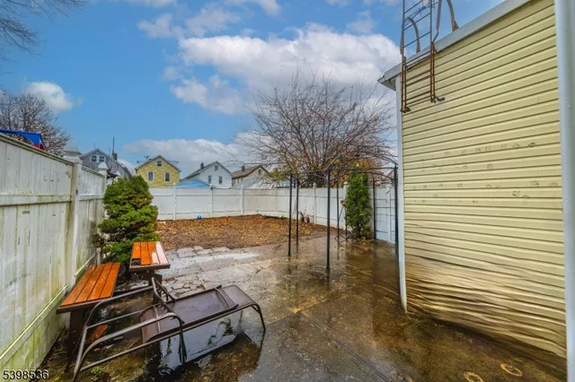 a backyard of a house with table and chairs