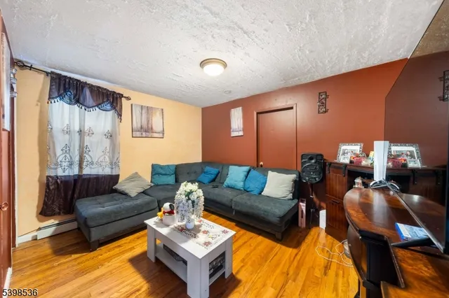 a living room with furniture a rug and a lamp