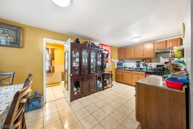 a kitchen with stainless steel appliances kitchen island granite countertop a refrigerator and a stove top oven