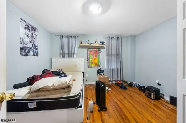 a bed sitting in a bedroom and chair