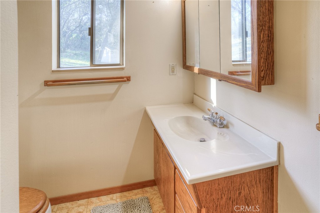 15 Hide A Way Road Oroville, CA 95966 - Photo 11 of 63 a bathroom with a sink and a mirror