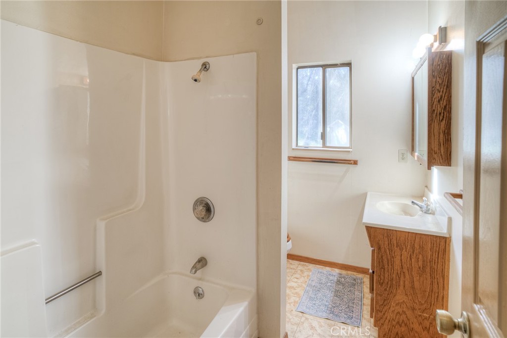 15 Hide A Way Road Oroville, CA 95966 - Photo 16 of 63 a bathroom with a bathtub and a shower