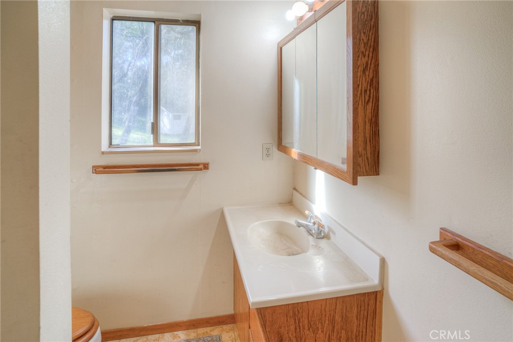 15 Hide A Way Road Oroville, CA 95966 - Photo 17 of 63 a bathroom with a sink and a window