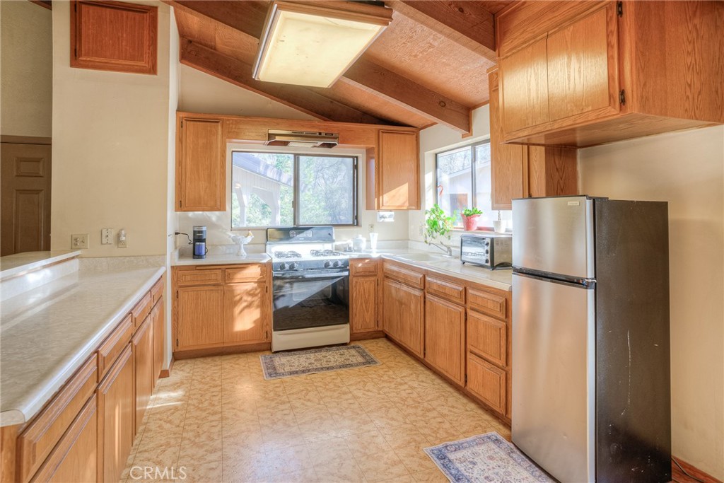15 Hide A Way Road Oroville, CA 95966 - Photo 22 of 63 a kitchen with stainless steel appliances sink refrigerator and window