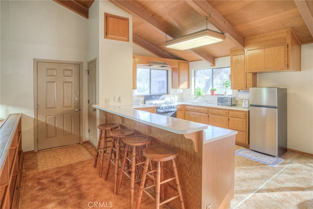 15 Hide A Way Road Oroville, CA 95966 - Photo 28 of 63 a kitchen with stainless steel appliances granite countertop a stove a sink and a refrigerator
