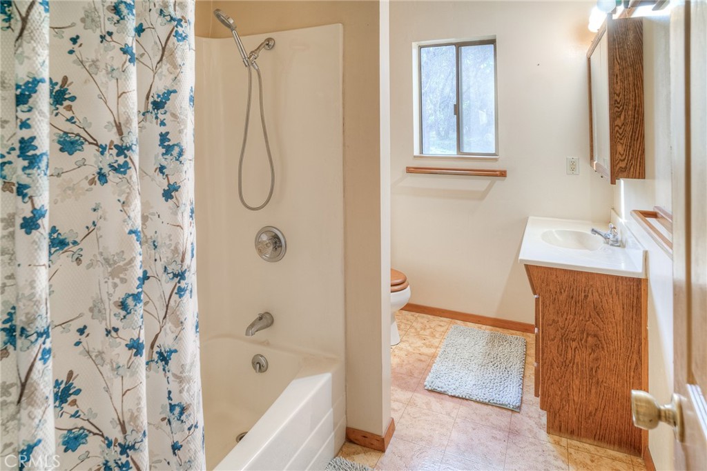 15 Hide A Way Road Oroville, CA 95966 - Photo 10 of 63 a bathroom with a shower curtain and a sink