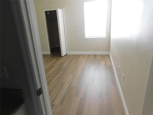 an entryway in a hallway with wooden floor