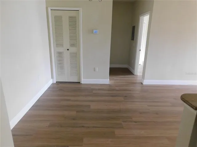 a view of a hallway with wooden floor