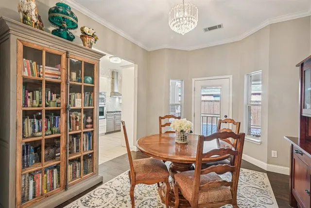 a dining room with furniture a book and wooden floor