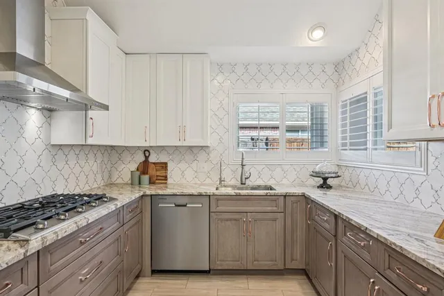 a kitchen with a sink stove and cabinets