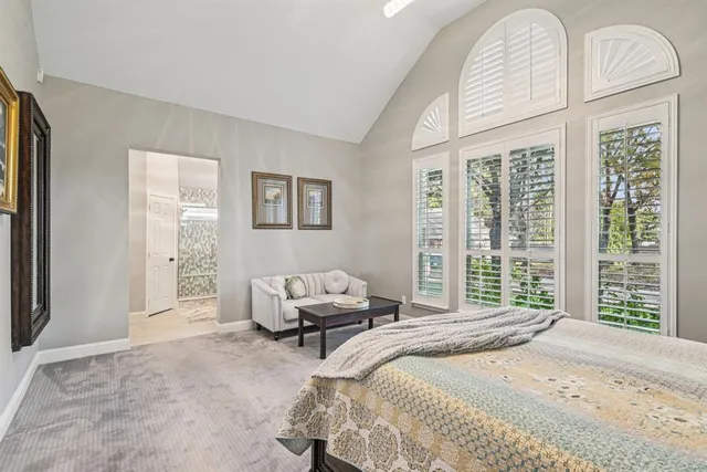 a bedroom with a large bed and a large window