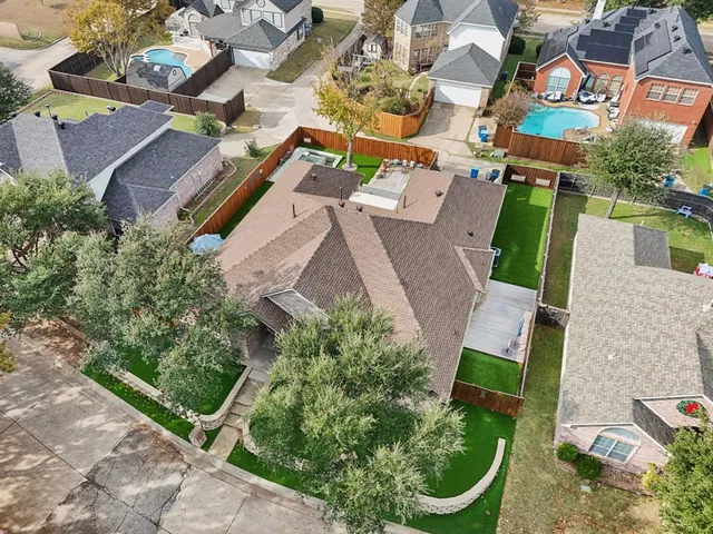 an aerial view of a house with garden space and street view