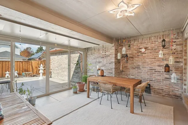 a dining room with furniture and a floor to ceiling window