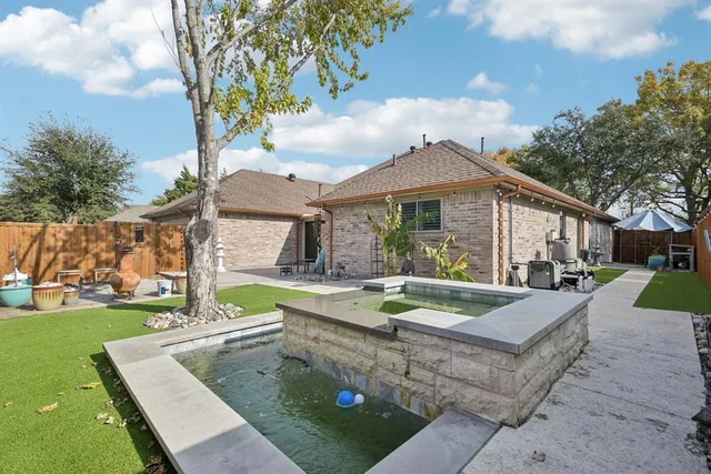 a view of a house with swimming pool and a yard