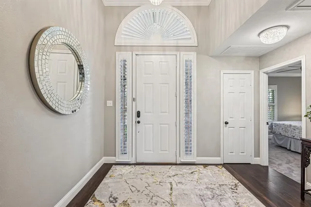 a view of a livingroom with wooden floor and a chandelier