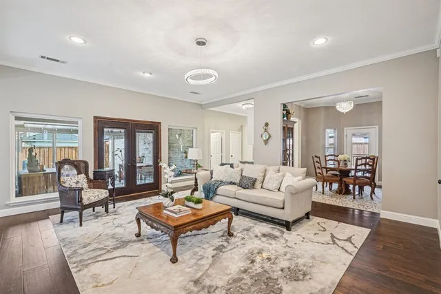 a living room with furniture and wooden floor