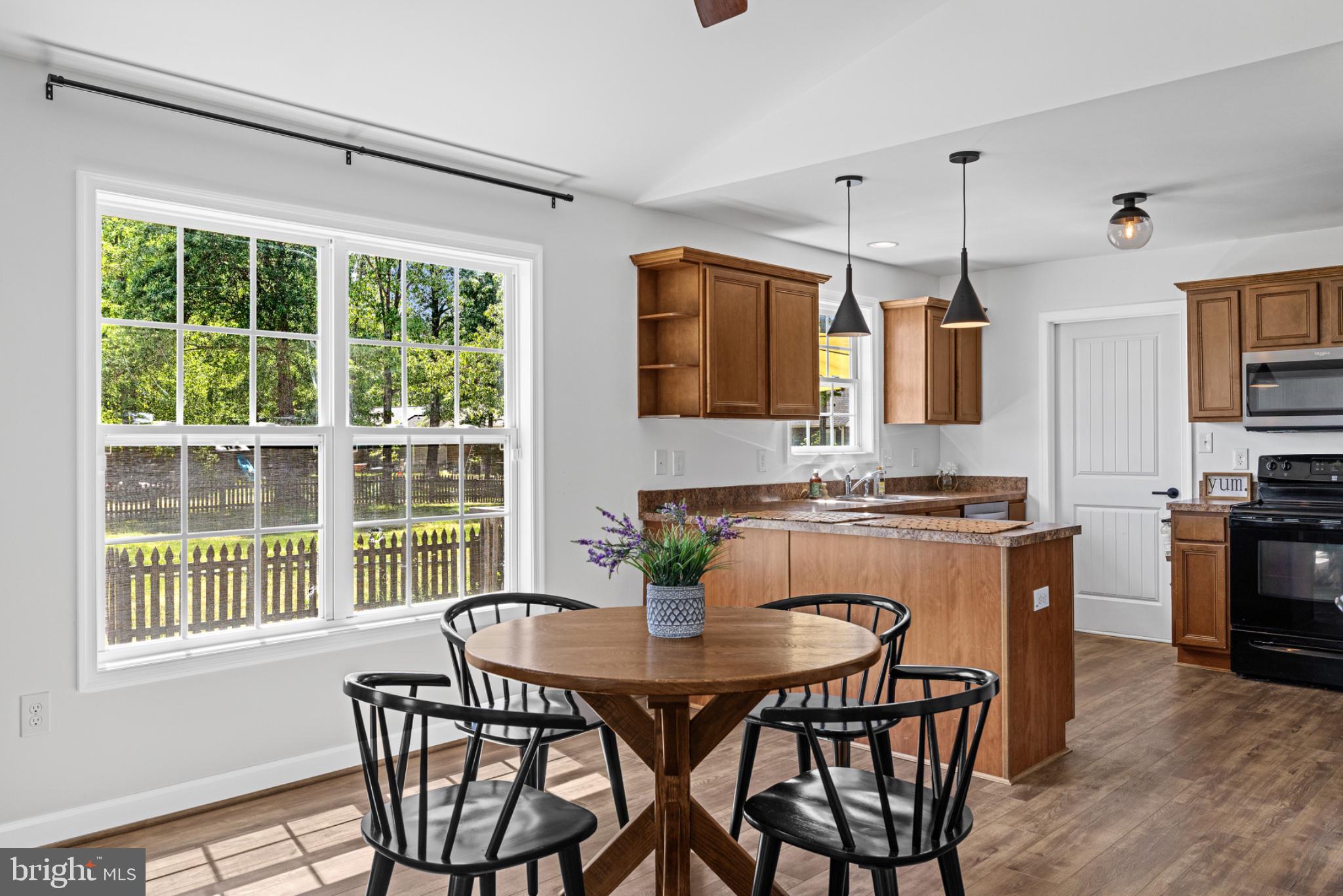 1523 Bowie Road Colonial Beach, VA 22443 - Photo 11 of 34 a kitchen with a table chairs stove and microwave